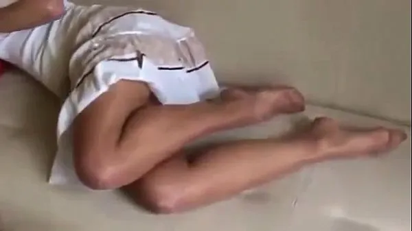 Black haired young girl in white dress shows her feet in sheer tan pantyhose Video mới lớn