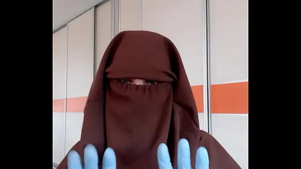 Housekeeper in apron putting on niqab Video baharu besar